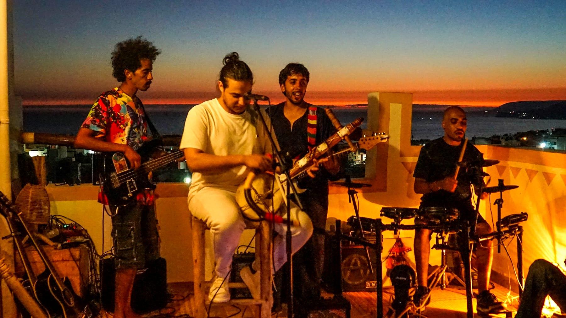 The full band at dusk on the rooftop
