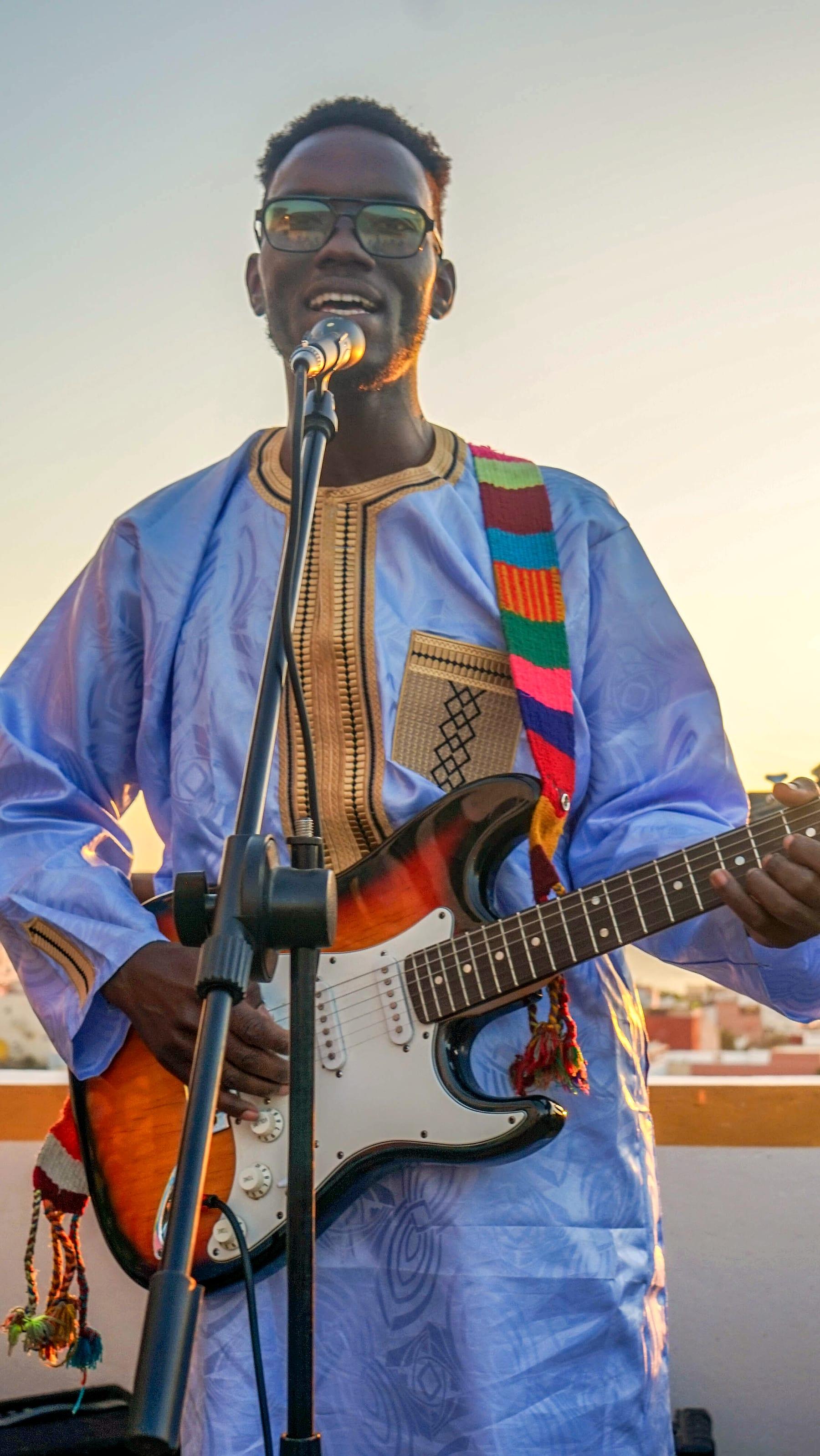 Singer with guitar at the rooftop jam